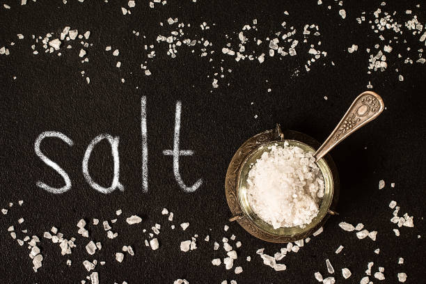 istock Salt in  jar on black background, top view 807218294