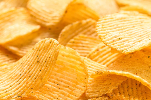istock Yellow salted potato chips as background, closeup 807218748