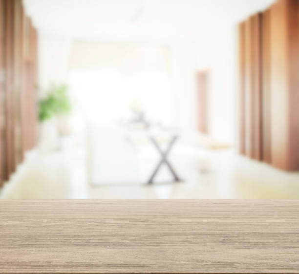 istock wooden table top with blur of modern dining room interior. 807230062
