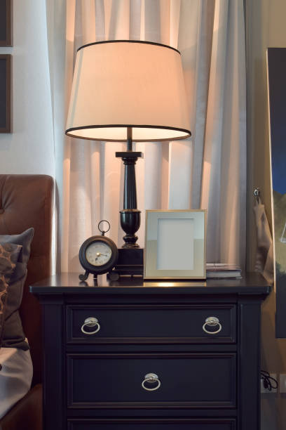 istock Cozy bedroom interior with pillows and reading lamp on bedside table 807230458