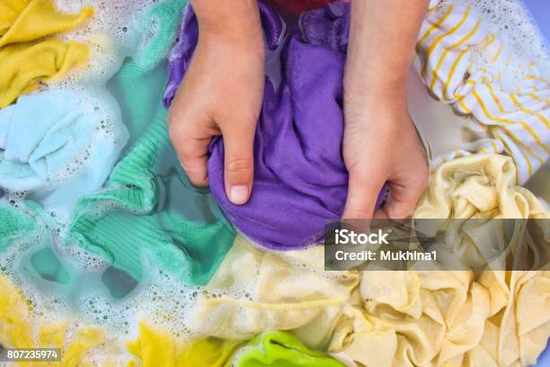 Female Hands Wash Colored Clothes In Basin Stock Photo - Download Image Now - Clothing, Washing, Hand