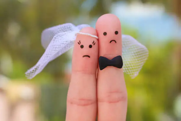 Photo of Fingers art of couple. Concept of wedding, woman and man needs to get married, but they don't want.