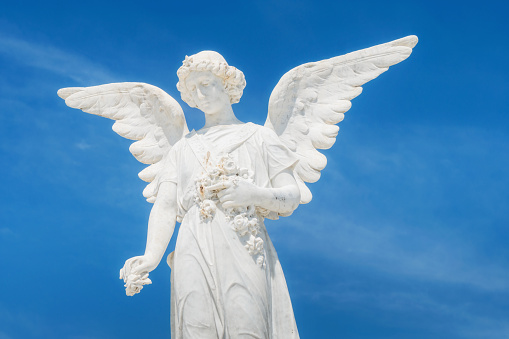 Beautiful young woman angel statue with wings. A symbol of hope