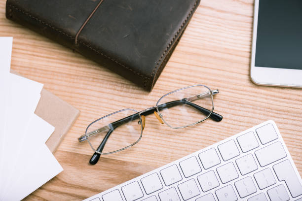 istock close up view of eyeglasses, notebook, smartphone and keyboard on table 807253622