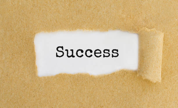 istock Text Success appearing behind ripped brown paper 807256406