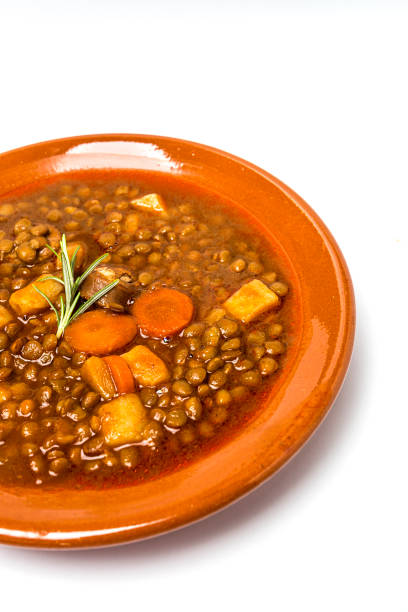 Stew of lentils with chorizo and pork.Isolated