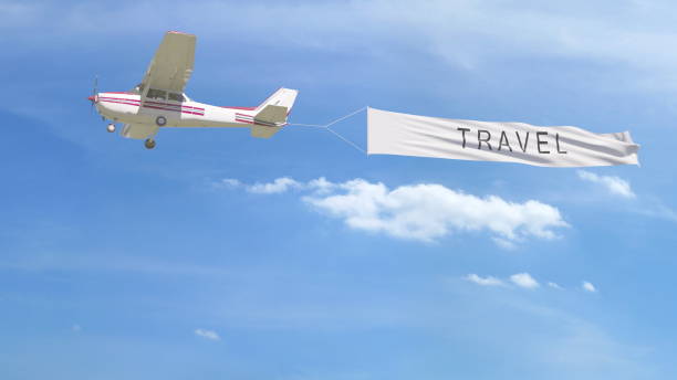 istock Small propeller airplane towing banner with TRAVEL caption in the sky. 3D rendering 807280624