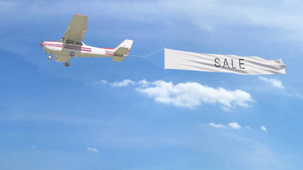 istock Small propeller airplane towing banner with SALE caption in the sky. 3D rendering 807280738