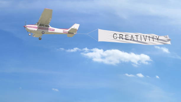 istock Small propeller airplane towing banner with CREATIVITY caption in the sky. 3D rendering 807281580