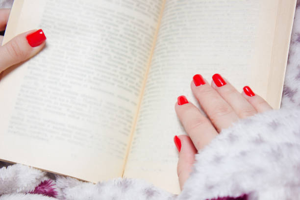 Open book, hardback books on wooden table, rose and white gloves knitted crochet Back to school. Copy space for text