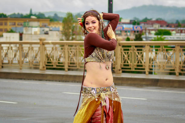 Portland, Oregon: Persian style belly dancer in the Grand Floral Parade, as it stretched through the rain, during Portland Rose Festival 2017.