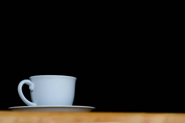 istock A white cup of coffee in the dark background. 807294638