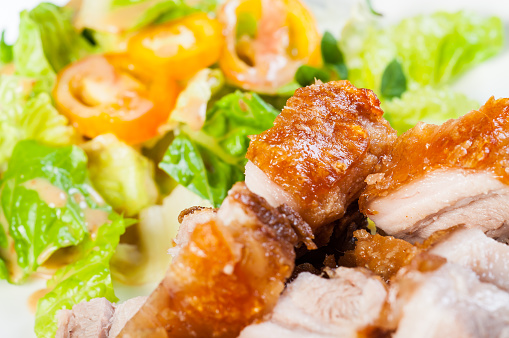 fried pork belly and oriental salad on a side