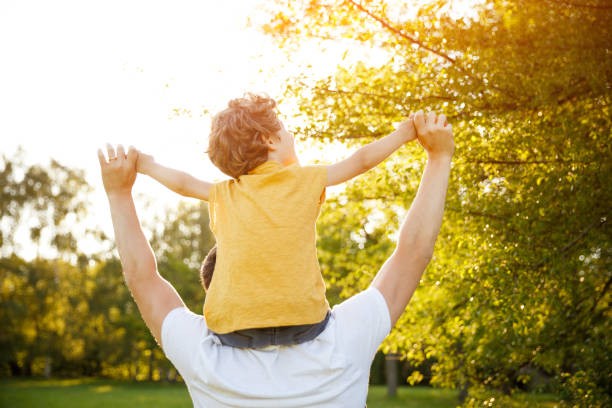 istock Young boy riding his fathers neck 807295296