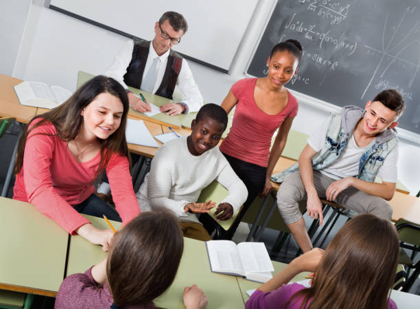 istock Girls and boys relaxing together between the classes 807302620