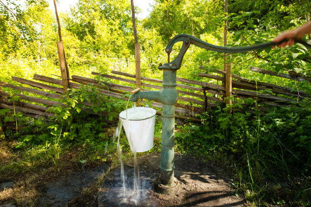 istock Old hand water pump outside in the garden 807307978