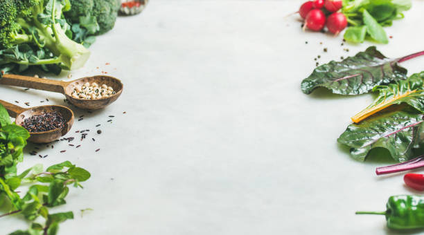istock Fresh greens, vegetables and grains over grey marble kitchen countertop 807308134
