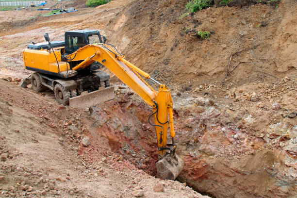 istock Excavator working on a construction site. Digging the trench for the pipeline. 807319298