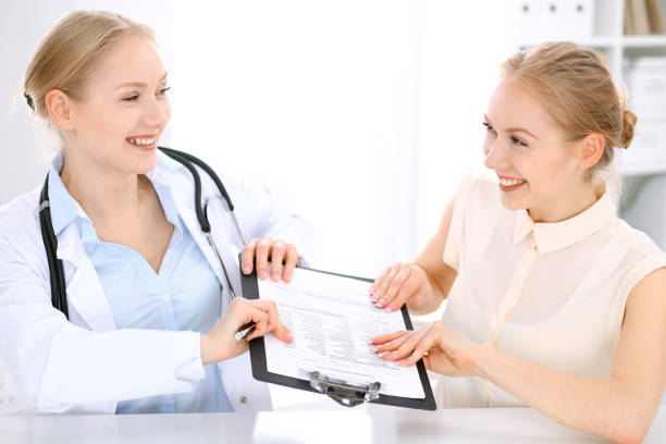 istock Doctor and  patient  sitting at the desk 807324224