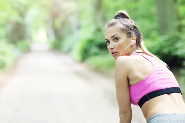 istock Exhausted woman jogging in the forest 807324436