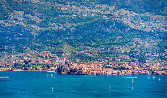 View on Malcesine from the opposite lake side at Tremosine. Malcesine located on the eastern shore of the lake in the Province of Verona (Veneto), is the most popular and scenic town at the Lake Garda.