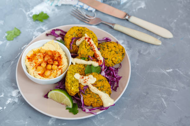 istock Baked falafel with hummus and vegetables. 807333106