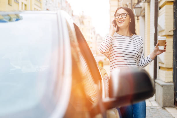 istock Young woman laughing while talking on the phone 807339968
