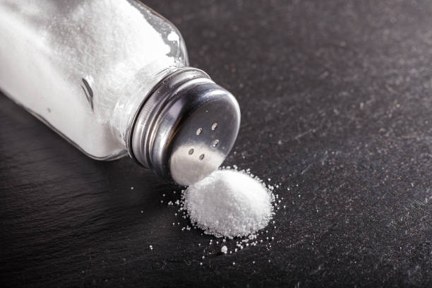 salt scattered from the salt shaker stock photo