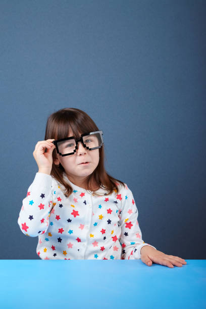 istock Happy girl with glasses making funny face 807367250