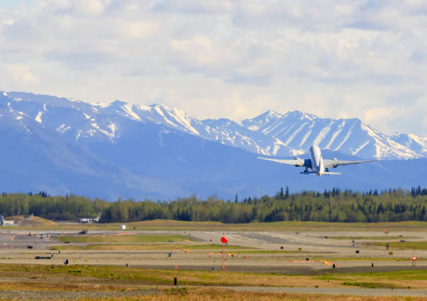Take off in Anchorage Anchorage, USA - May 17, 2017: An aircraft takeoff on the Ted Stevens International Airport in Anchorage. anchorage alaska photos stock pictures, royalty-free photos & images