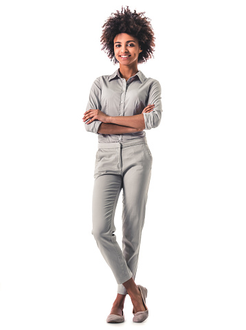 Full length portrait of beautiful young Afro American woman in smart casual wear smiling, isolated on white