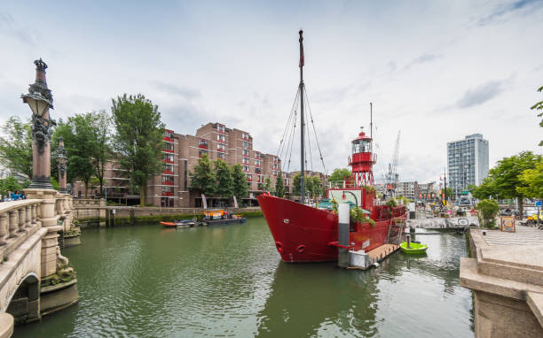 Vessel 11 boat, now used as a restaurant in Rotterdam, Netherlands. People sat on the boat eating food.