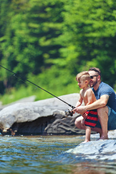 istock Father and son fishing 807384120