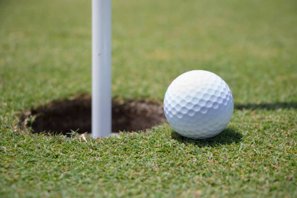 istock Golf Ball Near Hole 807388476