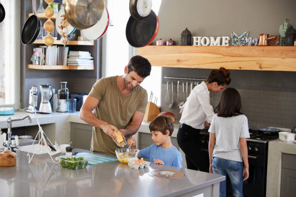 istock Family In Kitchen Making Morning Breakfast Together 807402070