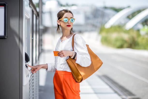 istock Woman buying a ticket or using ATM outdoors 807406112