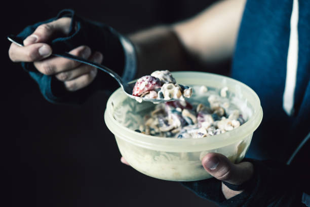 istock Man in gym eating healthy snack 807408822