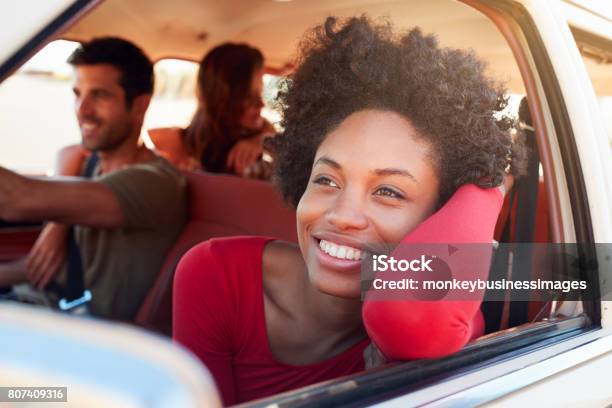 Group Of Friends Relaxing In Car During Road Trip Stock Photo - Download Image Now - Car, Friendship, Driving