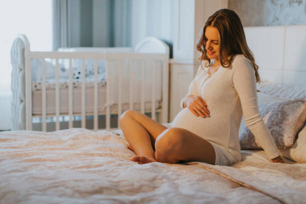 istock Pregnant woman on bed 807410044