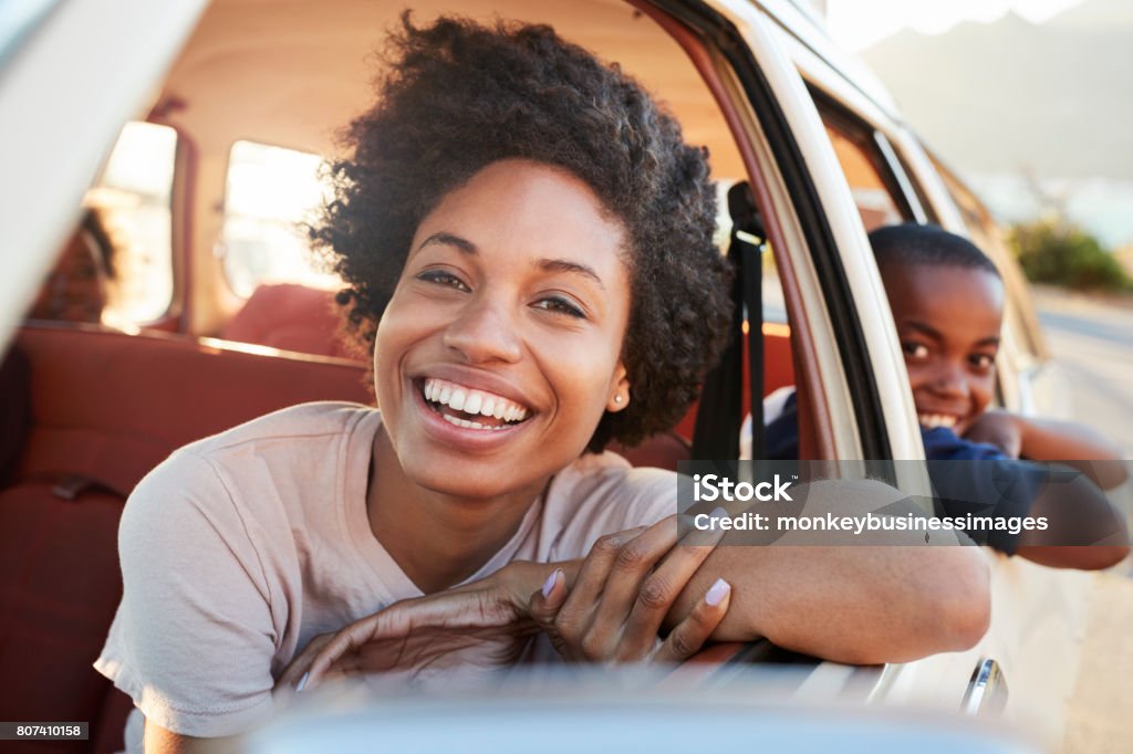 Portrait Of Mother And Children Relaxing In Car During Road Trip Car Stock Photo
