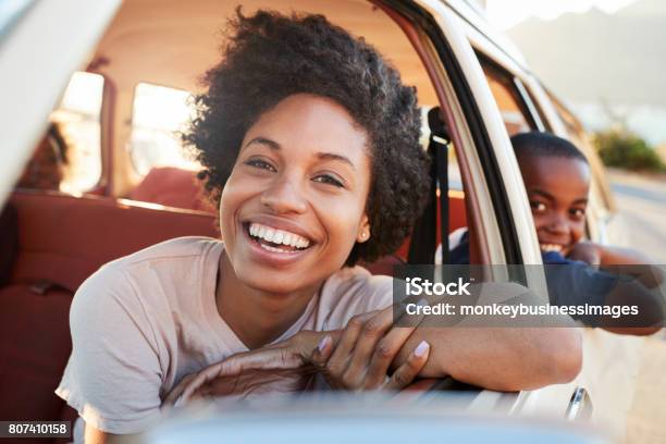 Portrait Of Mother And Children Relaxing In Car During Road Trip Stock Photo - Download Image Now