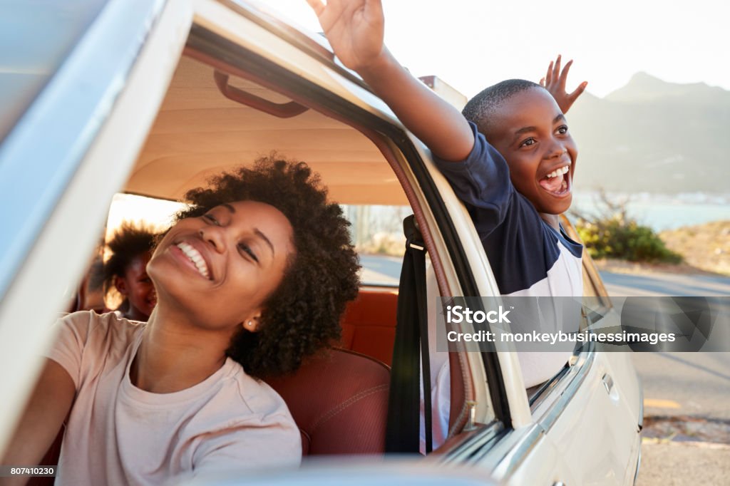 Mother And Children Relaxing In Car During Road Trip Car Stock Photo