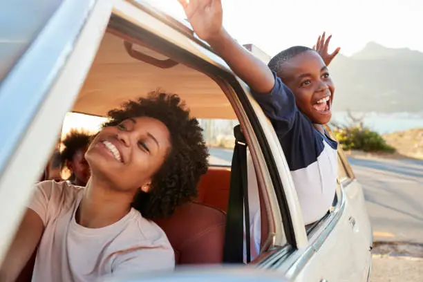 Photo of Mother And Children Relaxing In Car During Road Trip