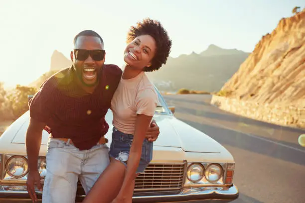 Photo of Portrait Of Young Couple Standing Next To Classic Car