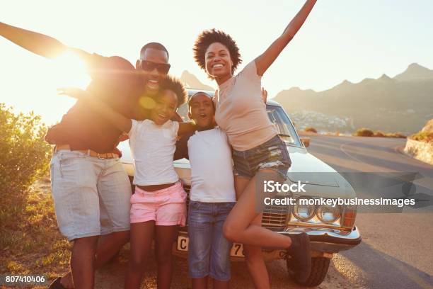 Portrait Of Family Standing Next To Classic Car Stock Photo - Download Image Now - Family, Road Trip, Car