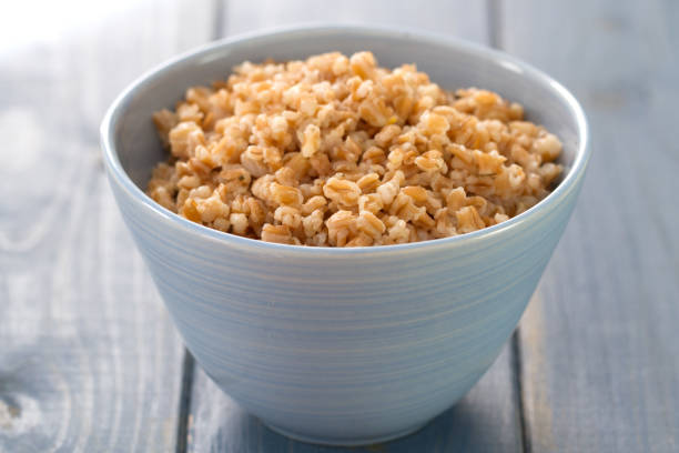 istock spelt in blue bowl on blue wooden background 807410782