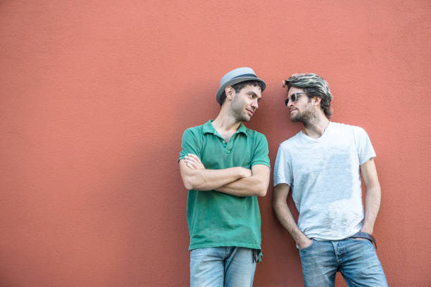istock Gay couple on red background 807415018