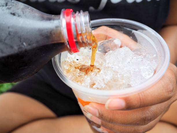 istock Woman pouring cola drink 807416048