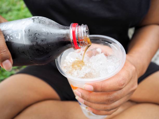 istock Woman pouring cola drink 807416094