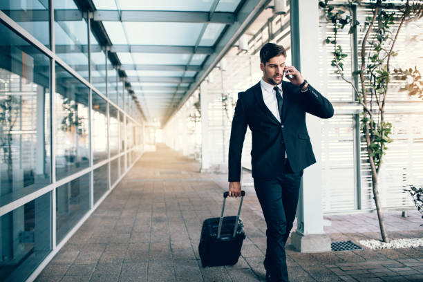 istock Travelling businessman making phone call 807418518